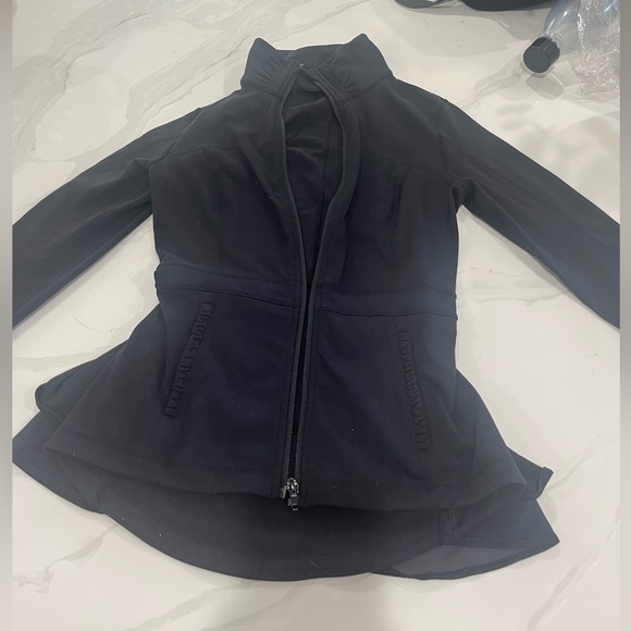 Black Lululemon define jacket with skirt design one hidden pocket on the front. - Picture 1 of 3